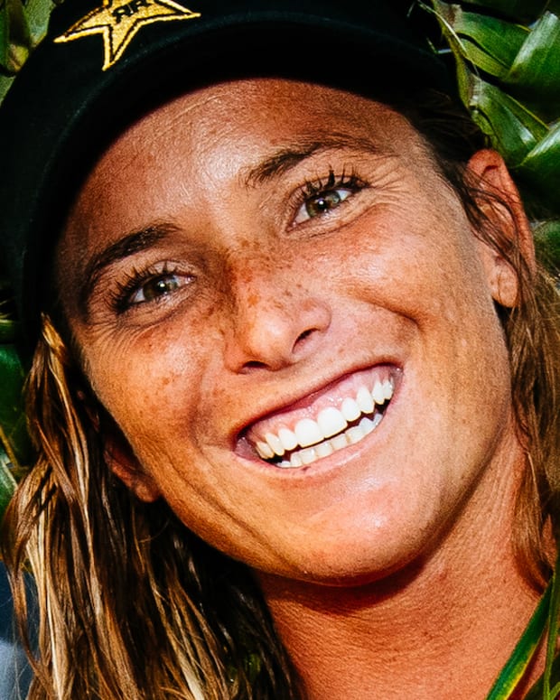 Courtney Conlogue wears a green braided hat and smiles for the camera.